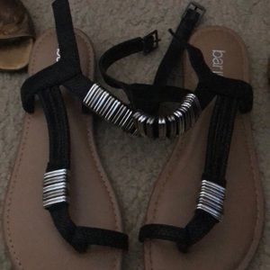 Black sandals with silver jewels.